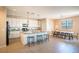 Open kitchen featuring a large island with seating, modern appliances, and adjacent dining area at 7733 Harthill Park Ave, Las Vegas, NV 89113
