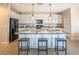 Kitchen island featuring granite countertops, pendant lighting, and bar stool seating at 7733 Harthill Park Ave, Las Vegas, NV 89113