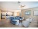 Spacious living room with tile floors, neutral tones, an open floor plan, and a comfortable blue sofa at 7733 Harthill Park Ave, Las Vegas, NV 89113