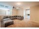 Upstairs living room with plush sectional sofa, ceiling fan, and built in cabinets at 7733 Harthill Park Ave, Las Vegas, NV 89113