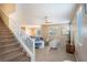 Inviting living room with neutral tones, carpeted stairs, large windows, and an open concept floor plan at 7733 Harthill Park Ave, Las Vegas, NV 89113