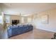 Spacious living room with a large sectional sofa, neutral tones, and ample natural light at 7733 Harthill Park Ave, Las Vegas, NV 89113