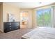 Serene bedroom with balcony access, neutral tones, and en suite bathroom view at 7733 Harthill Park Ave, Las Vegas, NV 89113