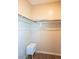 Simple walk-in closet with hanging rods and a small chest of drawers offers practical storage at 7733 Harthill Park Ave, Las Vegas, NV 89113