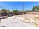 A backyard features a cement slab, a grill, a fence, and some foliage at 805 E Carey Ave, North Las Vegas, NV 89030