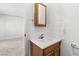 Small bathroom featuring a wood vanity, sink, mirror, and tiled wall at 805 E Carey Ave, North Las Vegas, NV 89030