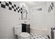 Compact bathroom featuring a tiled shower-tub combination, sink and toilet at 805 E Carey Ave, North Las Vegas, NV 89030