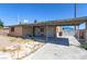 A single story home features a carport, trash cans, satellite dishes, and utility lines overhead at 805 E Carey Ave, North Las Vegas, NV 89030