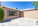Low angle view of a tan single-story home featuring a secure window, and a tan front door at 805 E Carey Ave, North Las Vegas, NV 89030