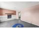 Spacious living room with a classic fireplace, concrete floors, and neutral-toned walls at 805 E Carey Ave, North Las Vegas, NV 89030