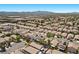 Overhead shot presenting a housing development with neat rows of houses, solar panels, and green trees at 8563 Red Diamond St, Las Vegas, NV 89123