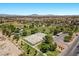 An aerial shot shows a park with sport courts and play areas in a neighborhood at 8563 Red Diamond St, Las Vegas, NV 89123