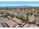 An aerial view of a neighborhood featuring houses with pools, solar panels, and a mix of well-maintained yards at 8563 Red Diamond St, Las Vegas, NV 89123
