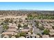 Stunning aerial perspective revealing a desert community with homes, green spaces, and distant cityscape at 8563 Red Diamond St, Las Vegas, NV 89123