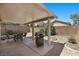 The backyard features a covered patio with barbecue perfect for entertaining at 8563 Red Diamond St, Las Vegas, NV 89123
