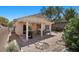 Charming backyard featuring a covered patio, barbecue and desert landscaping at 8563 Red Diamond St, Las Vegas, NV 89123