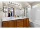 Bathroom features a dual sink vanity with a white countertop and tub with shower at 8563 Red Diamond St, Las Vegas, NV 89123