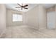 Neutral bedroom featuring tile floors, a ceiling fan, and a window for natural light at 8563 Red Diamond St, Las Vegas, NV 89123