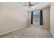Bedroom featuring neutral carpet, a window with blue curtains, and a ceiling fan at 8563 Red Diamond St, Las Vegas, NV 89123