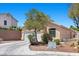 Single-story home with desert landscaping, an arched entryway, and a two-car garage at 8563 Red Diamond St, Las Vegas, NV 89123