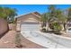 Single-story house featuring a two-car garage, desert landscaping, and concrete driveway at 8563 Red Diamond St, Las Vegas, NV 89123