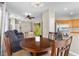 Bright kitchen and breakfast nook features wood cabinetry, stainless appliances, and granite countertops at 8563 Red Diamond St, Las Vegas, NV 89123