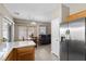 Well-lit kitchen features stainless appliances, wood cabinetry, granite countertops, and adjacent living space at 8563 Red Diamond St, Las Vegas, NV 89123