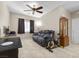 Well-lit living room featuring a ceiling fan and a comfortable gray couch at 8563 Red Diamond St, Las Vegas, NV 89123