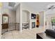 Living room boasts neutral paint, tile floors, a fireplace, TV, and plenty of natural light at 8563 Red Diamond St, Las Vegas, NV 89123