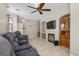 Living room with a fireplace, a ceiling fan, and tile floors at 8563 Red Diamond St, Las Vegas, NV 89123