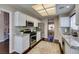 Bright kitchen featuring white cabinets, stainless steel appliances, granite countertops, and a view to the dining room at 8808 Litchfield Ave, Las Vegas, NV 89134
