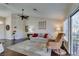 Comfortable living room with hardwood floors, ceiling fan, sofa, and natural light at 8808 Litchfield Ave, Las Vegas, NV 89134