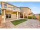 Backyard features a covered patio, artificial turf, and brick pavers at 8930 W Ford Ave, Las Vegas, NV 89148