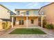 Backyard features a covered patio, artificial turf, and brick pavers at 8930 W Ford Ave, Las Vegas, NV 89148
