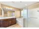 Bathroom features a double sink vanity, tub, and glass shower at 8930 W Ford Ave, Las Vegas, NV 89148