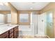 Bathroom with double vanity, tub, and separate glass enclosed shower at 8930 W Ford Ave, Las Vegas, NV 89148