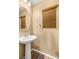Charming half-bathroom featuring a pedestal sink and decorative mirror for guests at 8930 W Ford Ave, Las Vegas, NV 89148