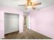 Bedroom featuring pink walls, carpet, closet, and a white door at 8930 W Ford Ave, Las Vegas, NV 89148