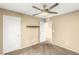Bedroom with neutral walls, carpet, ceiling fan and two closets with doors at 8930 W Ford Ave, Las Vegas, NV 89148