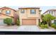 Inviting two-story home featuring a well-maintained front yard and attached two-car garage at 8930 W Ford Ave, Las Vegas, NV 89148