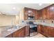 Kitchen showcasing granite countertops, stainless steel appliances, and decorative backsplash at 8930 W Ford Ave, Las Vegas, NV 89148