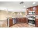 Open kitchen with stainless steel appliances and granite countertops, perfect for cooking and entertaining at 8930 W Ford Ave, Las Vegas, NV 89148