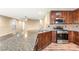 Bright kitchen featuring granite countertops, stainless steel appliances, and ample cabinet space at 8930 W Ford Ave, Las Vegas, NV 89148