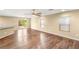Spacious living area with hardwood floors, sliding door to backyard, and neutral-colored walls at 8930 W Ford Ave, Las Vegas, NV 89148