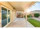 An inviting covered patio with sliding glass doors and sleek concrete flooring, seamlessly blending indoor and outdoor living spaces at 8930 W Ford Ave, Las Vegas, NV 89148