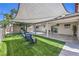 Spacious backyard features a covered patio, artificial turf, and a shaded play area at 905 Smith St, Las Vegas, NV 89108