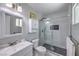 Charming bathroom featuring a shower with a glass door, white vanity, and a toilet at 905 Smith St, Las Vegas, NV 89108