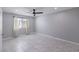 Empty bedroom featuring tile floors, window with blinds, and a ceiling fan at 905 Smith St, Las Vegas, NV 89108