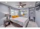 Cozy bedroom with large window, ceiling fan, mirrored closet, and a dedicated workspace at 905 Smith St, Las Vegas, NV 89108