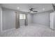 Neutral bedroom featuring tile floors, window with blinds, and a ceiling fan at 905 Smith St, Las Vegas, NV 89108